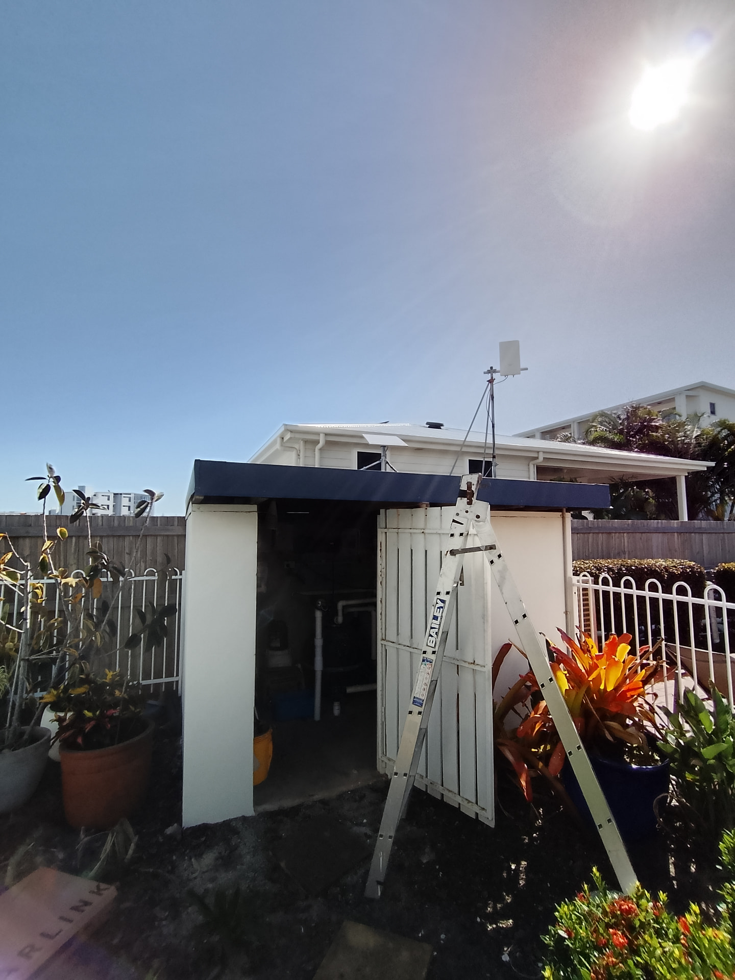 Wireless link antenna above an outbuilding